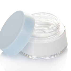 Open jar of cosmetic product isolated on white