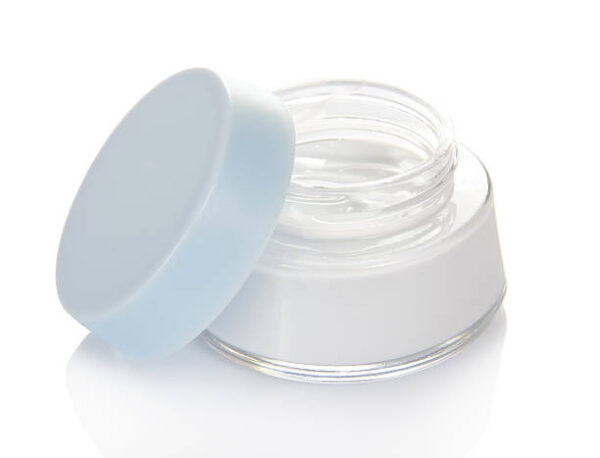 Open jar of cosmetic product isolated on white