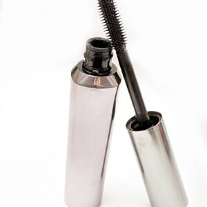 Black mascara isolated on a white background.